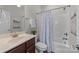 Clean bathroom with tub shower and dark wood vanity at 254 Streamside Pl, Mooresville, NC 28115