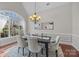 Elegant dining room with hardwood floors, large window, and chandelier at 254 Streamside Pl, Mooresville, NC 28115