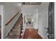 Bright entryway with hardwood floors, staircase, and views to living room at 254 Streamside Pl, Mooresville, NC 28115