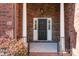 Dark-stained front door entry with stone surround at 254 Streamside Pl, Mooresville, NC 28115