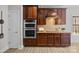 Kitchen features dark wood cabinets and stainless steel appliances at 254 Streamside Pl, Mooresville, NC 28115
