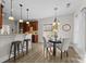 Modern kitchen with breakfast bar, pendant lighting, and hardwood floors at 254 Streamside Pl, Mooresville, NC 28115