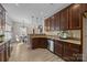 Eat-in kitchen with granite countertops and dark wood cabinets at 254 Streamside Pl, Mooresville, NC 28115