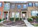 A stately brick townhome featuring attractive landscaping and inviting front entryway at 3033 Honeylocust Ln, Fort Mill, SC 29707
