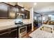 Open kitchen with island, granite counters, and stainless steel appliances at 3033 Honeylocust Ln, Fort Mill, SC 29707