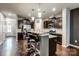 Open kitchen with island, granite counters, and stainless steel appliances at 3033 Honeylocust Ln, Fort Mill, SC 29707