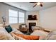Cozy living room features sectional sofa, fireplace, and patterned ottoman at 3033 Honeylocust Ln, Fort Mill, SC 29707