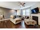Spacious living room with L-shaped sofa, fireplace, and ceiling fan at 3033 Honeylocust Ln, Fort Mill, SC 29707