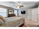 Main bedroom with TV mount above dresser, ceiling fan, and ensuite bath access at 3033 Honeylocust Ln, Fort Mill, SC 29707