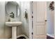 Elegant powder room with pedestal sink and mirrored vanity at 3033 Honeylocust Ln, Fort Mill, SC 29707