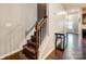 Staircase with dark wood treads and white risers at 3033 Honeylocust Ln, Fort Mill, SC 29707