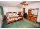 Bedroom with wooden furniture and green carpet at 338 Piney Grove Rd, Harmony, NC 28634