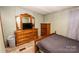 Bedroom with wood dresser, mirror and a bed at 338 Piney Grove Rd, Harmony, NC 28634