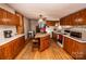 Kitchen with wood cabinets, granite island, and wood flooring at 338 Piney Grove Rd, Harmony, NC 28634