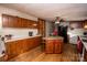 Cozy kitchen with wood cabinets, granite island, and hardwood floors at 338 Piney Grove Rd, Harmony, NC 28634