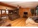 Relaxing living room with wood walls and hardwood floors at 338 Piney Grove Rd, Harmony, NC 28634