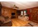 Living room features wood walls and hardwood floors at 338 Piney Grove Rd, Harmony, NC 28634