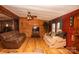 Living room with wood walls, hardwood floors, and comfy sofas at 338 Piney Grove Rd, Harmony, NC 28634