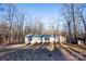 Single-wide manufactured home exterior with wooded backdrop at 338 Piney Grove Rd, Harmony, NC 28634