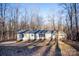 Single-wide manufactured home exterior with wooded backdrop at 338 Piney Grove Rd, Harmony, NC 28634
