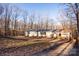 Single-wide manufactured home exterior with wooded backdrop at 338 Piney Grove Rd, Harmony, NC 28634