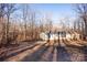 Single-wide manufactured home exterior with wooded backdrop at 338 Piney Grove Rd, Harmony, NC 28634
