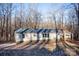 Single-wide manufactured home exterior with wooded backdrop at 338 Piney Grove Rd, Harmony, NC 28634
