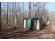 Tan and green storage shed nestled in a wooded area at 338 Piney Grove Rd, Harmony, NC 28634