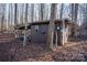 Rustic storage shed nestled in woods, offering extra storage space at 338 Piney Grove Rd, Harmony, NC 28634