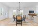 Bright dining room with modern chandelier and seating for six at 3804 Odom Way, Charlotte, NC 28216