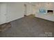 Open dining room with gray carpeting and a view to the kitchen at 4210 Manchester Ln, Monroe, NC 28110