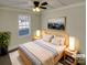 Virtually staged main bedroom with a ceiling fan and large window at 4210 Manchester Ln, Monroe, NC 28110
