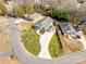 Aerial view of a community showcasing the property, well-manicured lawns, and mature trees at 502 Rhyne Cir, Gastonia, NC 28054