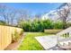 A fenced backyard features green grass and a small patio, perfect for outdoor enjoyment at 502 Rhyne Cir, Gastonia, NC 28054