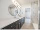 Modern bathroom with a walk-in shower and a double sink vanity with round mirrors at 502 Rhyne Cir, Gastonia, NC 28054