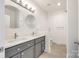 Stylish bathroom featuring double sinks, round mirrors, and modern lighting fixtures at 502 Rhyne Cir, Gastonia, NC 28054