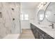 Elegant bathroom featuring a marble shower and double vanity with round mirrors at 502 Rhyne Cir, Gastonia, NC 28054