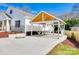 Exterior of a home featuring a carport with wooden beams and ample parking space on concrete at 502 Rhyne Cir, Gastonia, NC 28054