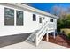 View of the exterior of a house with a deck and stairs leading to a white-sided home at 502 Rhyne Cir, Gastonia, NC 28054