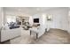 Open-concept living area with hardwood floors, modern furnishings, and seamless flow to kitchen and dining space at 502 Rhyne Cir, Gastonia, NC 28054
