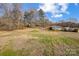 Spacious backyard with mature trees and neighboring homes at 516 Spring Garden Ave, Kannapolis, NC 28081