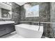 Spa-like bathroom with soaking tub and chandelier at 516 Spring Garden Ave, Kannapolis, NC 28081