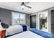 Two twin beds in a bedroom with gray walls and ceiling fan at 516 Spring Garden Ave, Kannapolis, NC 28081