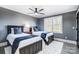 Two twin beds in a room with gray walls and ceiling fan at 516 Spring Garden Ave, Kannapolis, NC 28081