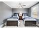 Two twin beds in a room with gray walls and ceiling fan at 516 Spring Garden Ave, Kannapolis, NC 28081