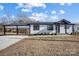 Modern farmhouse exterior with carport and landscaping at 516 Spring Garden Ave, Kannapolis, NC 28081