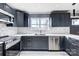 Modern kitchen with dark cabinetry, stainless steel appliances, and white subway tile at 516 Spring Garden Ave, Kannapolis, NC 28081