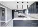 Modern kitchen with dark cabinetry, stainless steel appliances, and quartz countertops at 516 Spring Garden Ave, Kannapolis, NC 28081