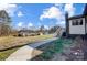 Landscaped side yard with walkway leading to modern home at 516 Spring Garden Ave, Kannapolis, NC 28081