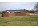 Expansive backyard featuring a well-maintained lawn and a brick wall bordering the property at 7169 Pleasant Grove Rd, Charlotte, NC 28216